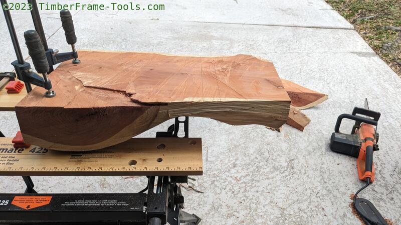 Cedar slab clamped for cutting.