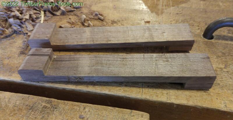 A pair of walnut bench hooks