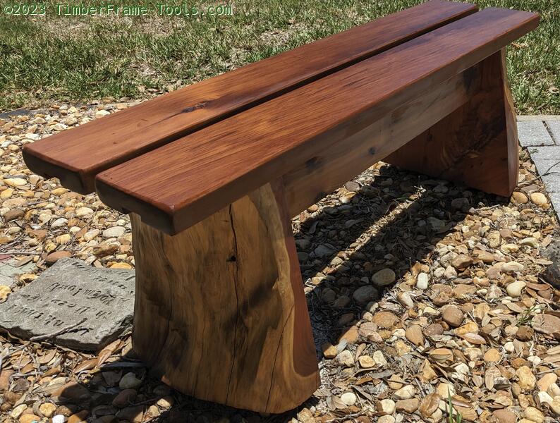 Outdoor cedar bench with slab legs.