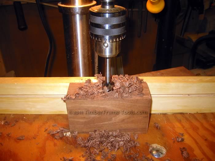 Using a Forstner bit to remove the majority of the mortise.